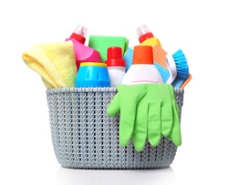 Plastic basket with domestic desinfectant bottles and sprays.Household item isolated on white.Housekeeping object.
