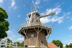 Countryside landscape of Netherlands, Traditional Dutch windmill with blue sky along Reitdiep river, Garnwerd is a small village in the municipality of Westerkwartier in the province of Groningen.
