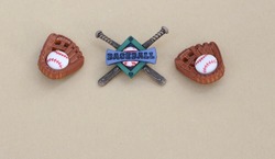 two baseball gloves with balls next to baseball banner on a tan background with writing space