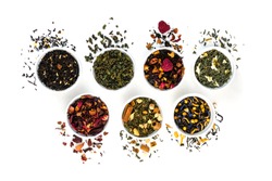 Assortment of dry tea in bowls isolated on white background. Red, fruit, green, black and herbal leaves dried fresh dessert beverage layout. Flat lay style. Top view concept. Healthy, organic drink