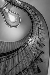 abstract shot of a staircase leading towards a light bulb like opening