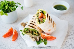 Burritos wraps with mushrooms and vegetables,  Mexican food.