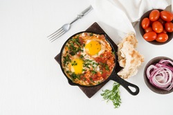 Shakshuka-a traditional Arabic dish made of eggs, peppers and tomatoes, copy space
