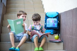 Children go back to school. Start of new school year after vacation. Two Boy friends with backpack and books on first school day. Beginning of class. Education for kindergarten and preschool kids.