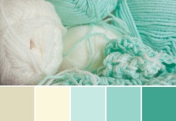 Close up colorful yarn texture background, light mint green and creamy beige strains. Shallow depth of focus. Color palette swatches, fresh trendy combination of colors for styling, pastel nuances.
