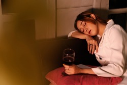 Drunk business woman fall asleep after drinking red wine too much.