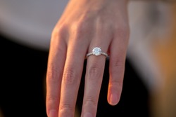 Engagement Ring On Woman's Hand During Sunset
