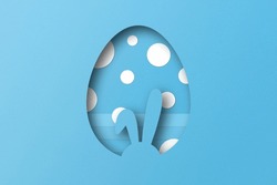Light blue paper cut to form an Easter egg pattern.