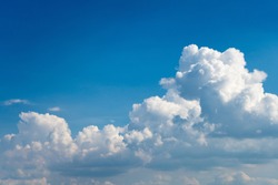Glowing clouds on a background of blue sky. White fluffy luminous cloud