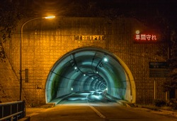 Tunnel, Toyama, Japan. TRANSLATION OF JAPANESE TEXT: use lights in tunnel; Asahi ogawa tunnel; keep your distance; length 1316m; emergency phones every 200m; call buttons, 50m; extinguishers, 50m.