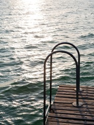 Swimming or Dock Ladder on a Jetty or Pier called Il Pontile di Sirmione on Lake Garda, Italy