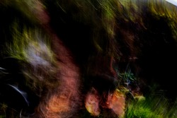 Psychedelic, hyper-realistic, vibrant multicolor image of hiker's shadow on mountain footpath pattern - abstract, motion-blurred background texture