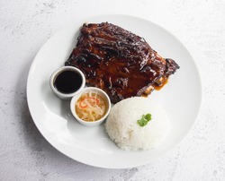 Pork ribs are a cut of pork popular in Western and Asian cuisines. The ribcage of a domestic pig, meat and bones together, is cut into usable pieces.