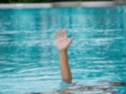 Hand of a drowning man asking for help. Blurred image.