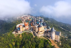 Aerial view of landscape is castles covered with fog at the top of Bana Hills, the famous tourist destination of Da Nang, Vietnam. Near Golden bridge.