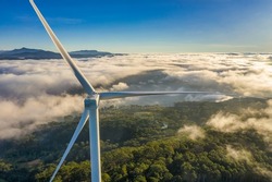 Aerial view of windmill or wind farm in fog  at Cau Dat town, Da Lat city, Lam Dong, Vietnam