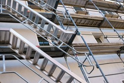 Frame of metal scaffolding with ladders on a building under construction.