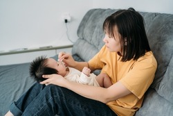 Young mother is breastfeeding newborn baby