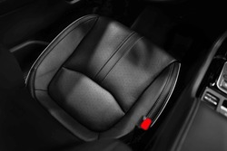 High angle view of luxury sport car front driver seat with leather texture. Car interior, car detailing and auto industry design element background.