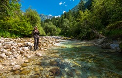 Fly fisherman fishing for trout in river
