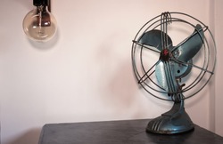 Old fashioned and rusty fan used as a decoration element for a night table in a bedroom. Design and style. Ideas for home.