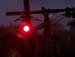  Illuminated bicycle front and rear light at dusk. Selective focus.
