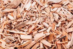 Small pile of wood chips background, top view. Waste from the woodworking industry, fuel and raw materials for heating solid fuel industrial boilers on wood chips