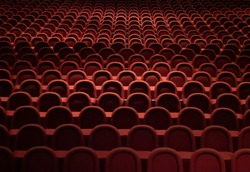 Many empty red seats in the theater.