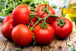 Close-up of fresh, ripe tomatoes on wood background