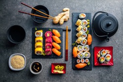 japanese sushi food. Maki ands rolls with tuna, salmon, shrimp, crab and avocado. Top view of assorted sushi. Rainbow sushi roll, uramaki, hosomaki and nigiri. 