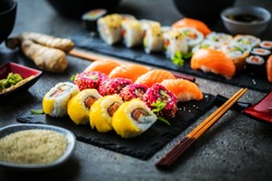 close-up view of delicious sushi set on slate boards
