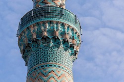 The minaret of Green Mosque (Yesil camii) in iznik (Nicaea). Close up fragment, famous iznik tiles decoration. Blue sky and clouds at background. Iznik (Bursa region), Turkey