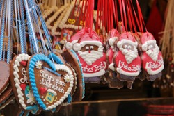 Heart and Santa gingerbread Lebkuchen cookies saying Merry Christmas in German (Frohes Fest), winter themed sweets at Christmas market. Bavarian souvenir dessert from Munich, typical for Oktoberfest