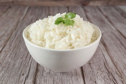 White rice in bowl on wood table