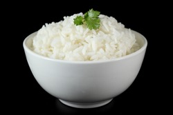 White rice in bowl, black background