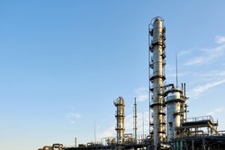Oil refinery chemical plant wide view with copyspace over blue evening sky with clouds background. Methanol production distillation refinery columns industrial background with copyspace.