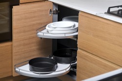 Kitchen access mechanism Magic corner for Blind Corner Cabinets. Solution for a kitchen corner storage in cupboard. Corner unit with pull out shelves for cookware.