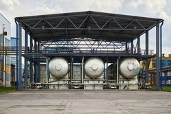 Carbon dioxide production plant. Cryogenic CO2 tank carbonic acid distillation storage. Part of petrochemical plant three cryogenic tanks with CO2 under canopy heat protection export filling device.