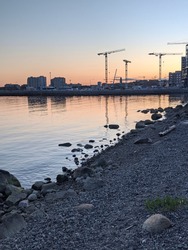 Silhouette of Construction Cranes and Baltic Sea at Kalasatama Helsinki Finland
