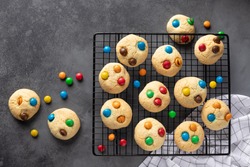 Cookies with colorful candies on baking sheet. Birthday, food, pastry background, greeting card. dark background. horizontal image. flat lay. copy space