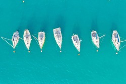 Top view of boats and yachts in the marina from above. Marina, Marina, Yacht and sailboat are moored to the pier. Aerial view by drone. Italy, sunny coast