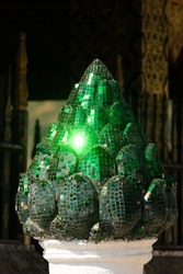 Figure of a fruit decorated with bright green glass, at the temple Wat Xieng Thong, in Luang Prabang, Laos