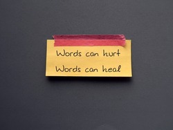 Yellow note stick on blue background with text Words can hurt Words can heal - to remind language have power to harm or heal - word choice matters most so choose wisely