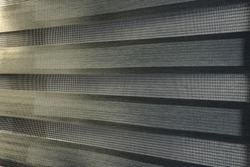 Example of moiré pattern in roller blinds with very fine rectangles. Pattern is caused by wave interference or diffraction.