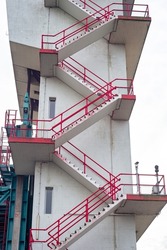 Red painted stairs on an industrial concrete tower