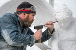 Sculptor at work .  Stone carving.