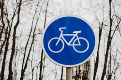 a blue bicycle sign sign signifying a bike path.