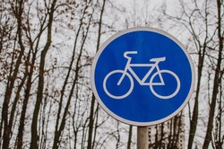a blue bicycle sign sign signifying a bike path.