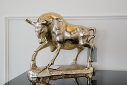Golden bull figurine. The golden calf is a symbol of profit, power, money, wealth.Golden bull figurine close-up
