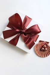 gift concept. gift box with brown bow and jewelry isolated on white background. women's accessories
